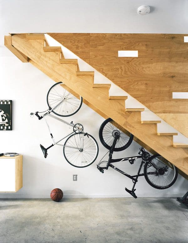 Vélos suspendus sous escalier en bois contemporain